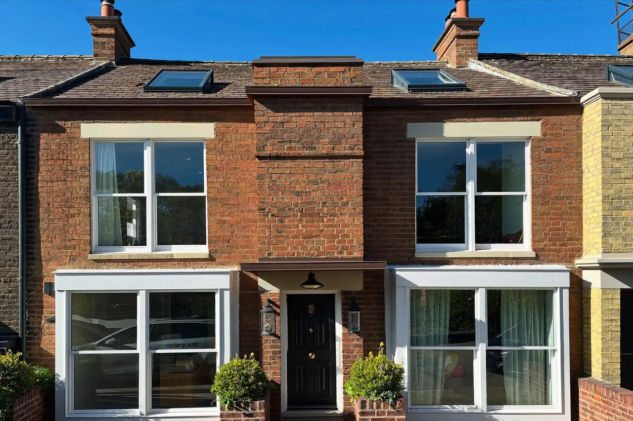 Terraced UK house fitted with new double glazed windows in daylight